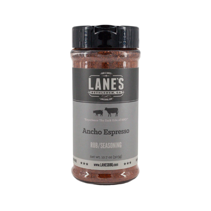 Lane’s Ancho Espresso Rub bottle beside grilled steak and espresso beans.