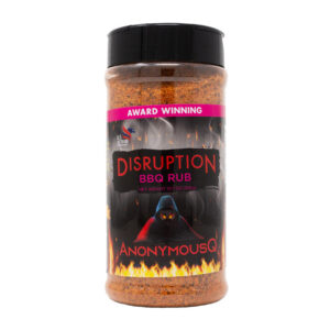 AnonymousQ Disruption BBQ Rub beside glazed ribs and brisket