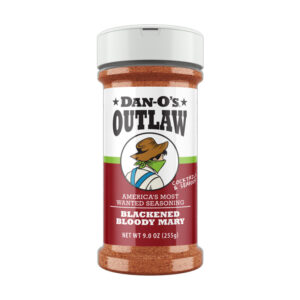 Dan-O’s Blackened Bloody Mary bottle beside cocktail glass.