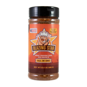 Bottle of Blazing Star All In One Seasoning beside grilled chicken, steak, and vegetables