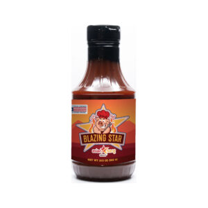 Bottle of Blazing Star Asian Bang Sauce beside grilled chicken, shrimp, and rice bowl