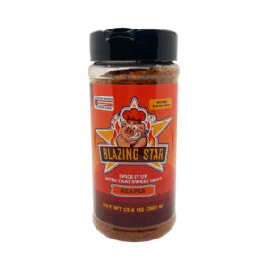 Bottle of Blazing Star Scorpion Rub & Seasoning beside spicy smoked ribs and chicken wings
