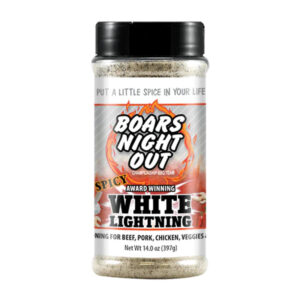 Bottle of Boar’s Night Out Spicy White Lightning beside grilled steak and ribs