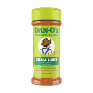 Dan-O’s Chili Lime bottle with lime wedges and chili peppers.
