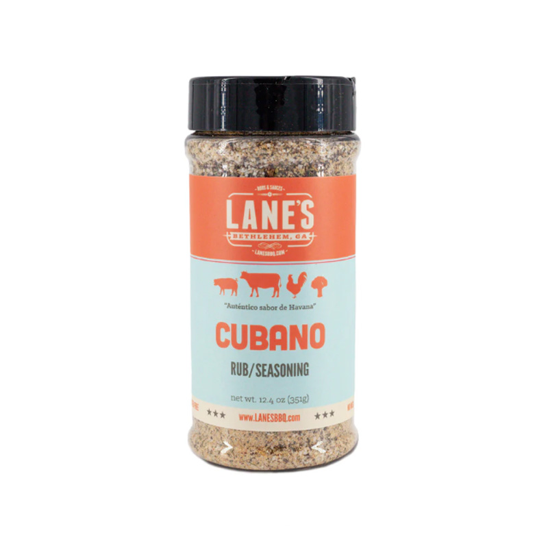 Lane’s Cubano Rub jar beside grilled pork and lime wedges.