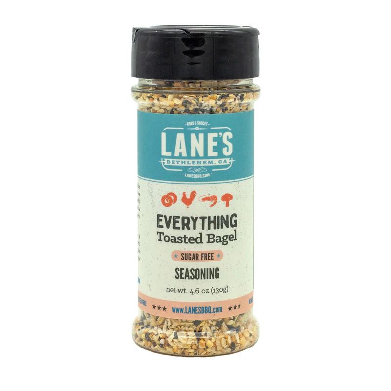 Lane’s Everything Toasted Bagel Rub jar beside avocado toast and eggs.