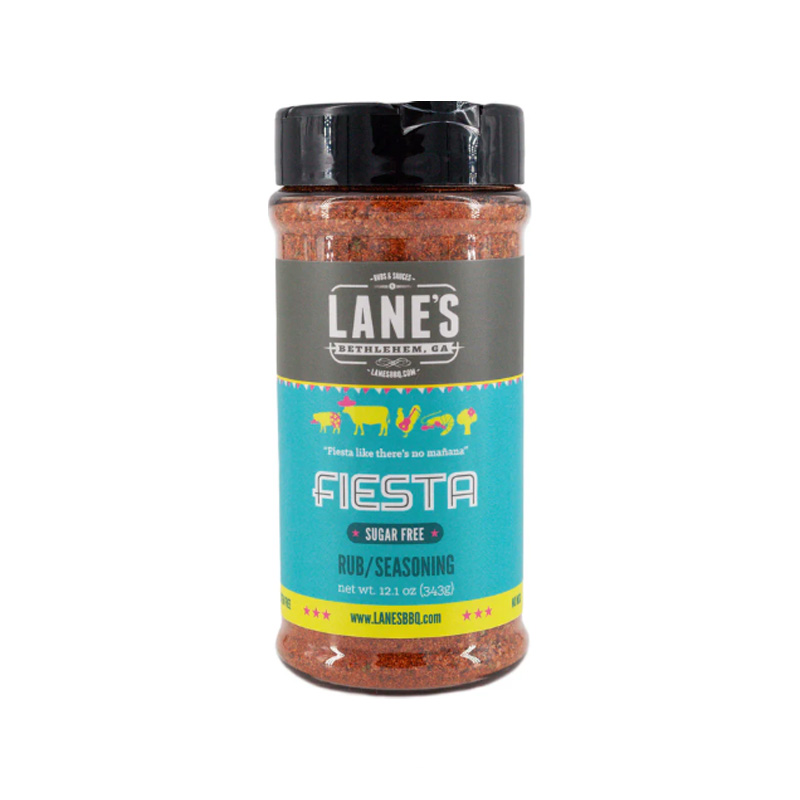 Lane’s Fiesta Rub jar beside grilled chicken tacos and lime wedges.