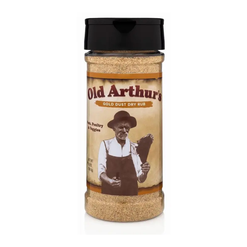 Old Arthur’s Gold Dust Dry Rub bottle beside grilled ribs and golden BBQ glaze.