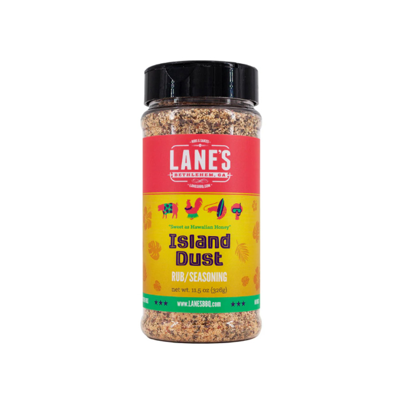 Lane’s Island Dust Rub jar beside grilled pineapple, shrimp, and chicken skewers.
