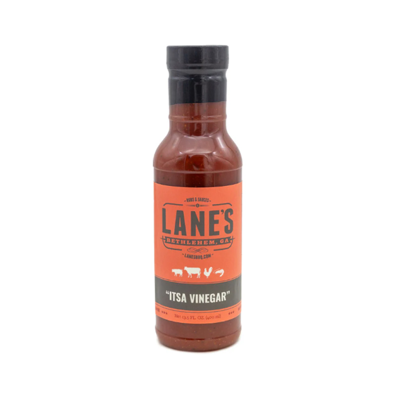 Lane’s Itsa Vinegar Sauce bottle beside pulled pork sandwich and coleslaw.