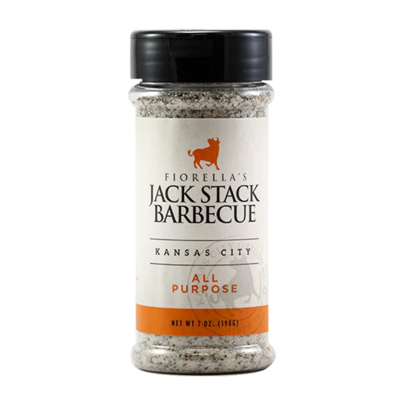 Bottle of Jack Stack All Purpose Rub beside grilled ribs and vegetables
