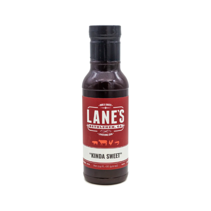 Lane’s Kinda Sweet BBQ Sauce bottle beside glazed ribs and grilled chicken.