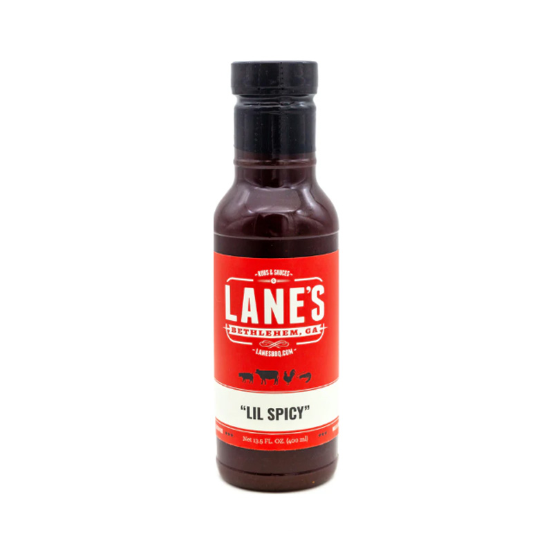 Lane’s Lil Spicy BBQ Sauce bottle beside glazed ribs and spicy wings.