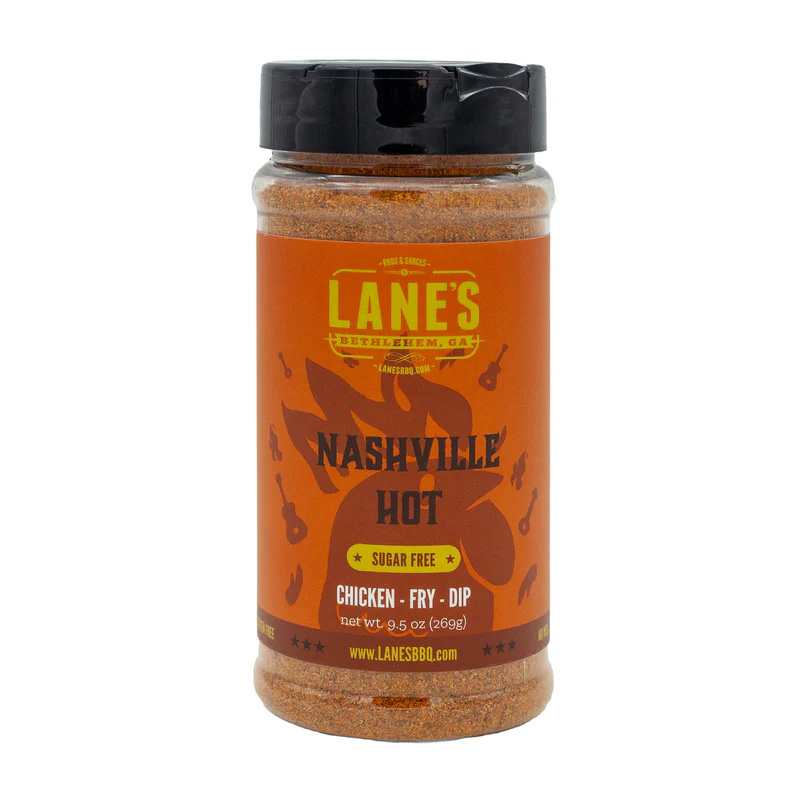 Lane’s Nashville Hot Rub jar beside spicy fried chicken and pickles.