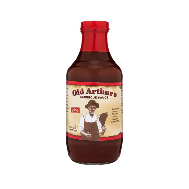 Old Arthur’s Hot & Spicy Barbecue Sauce bottle beside grilled ribs and chili peppers.
