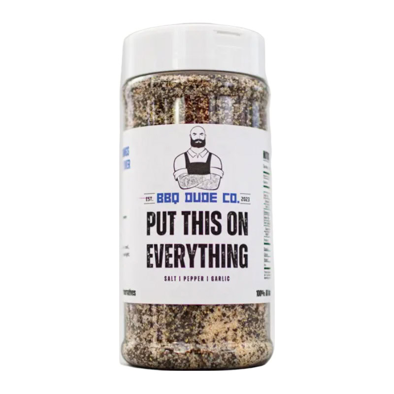 BBQ Dude Put This On Everything Seasoning bottle beside grilled steak and veggies.