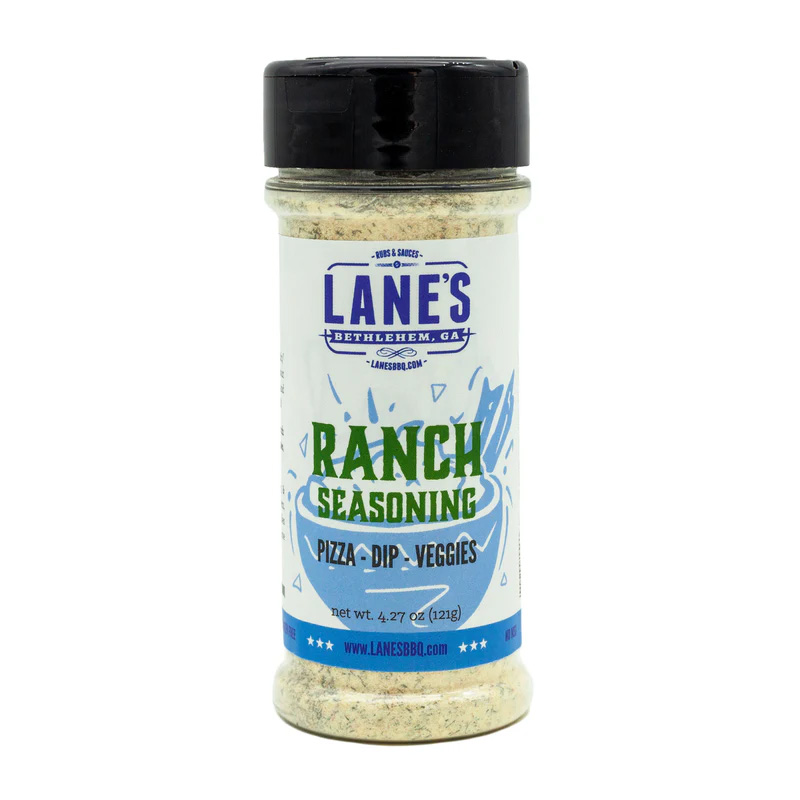 Lane’s Ranch Rub jar beside fries, chicken wings, and ranch dip.
