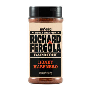 Bottle of Richard Fergola Barbecue Honey Habanero Rub beside smoked wings and ribs