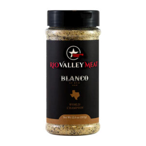 Bottle of Rio Valley Meat Blanco All-Purpose Rub beside grilled brisket and chicken