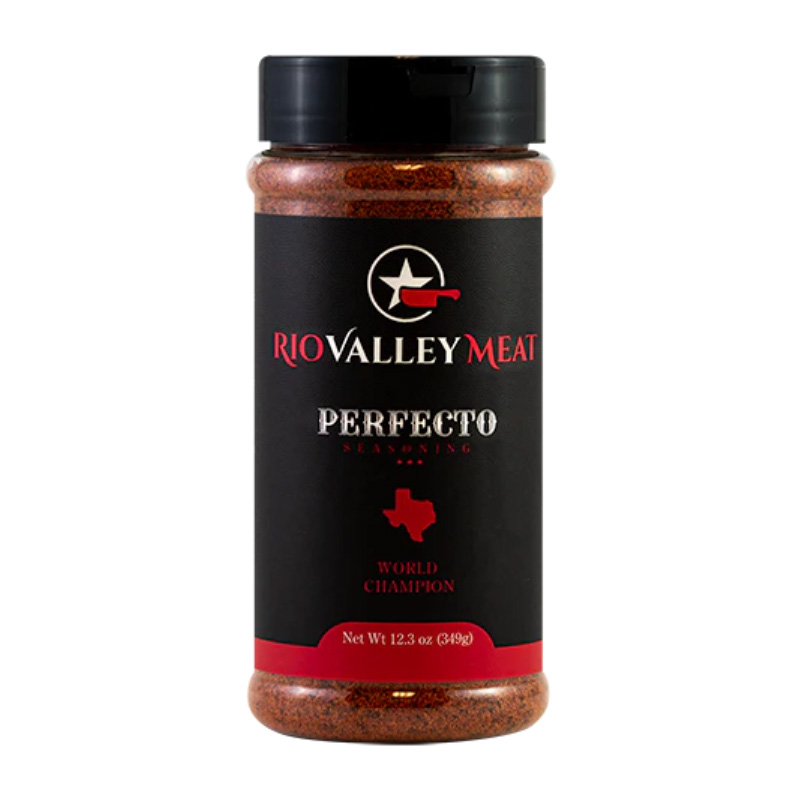 Bottle of Rio Valley Meat Perfecto Rub beside smoked brisket and ribs