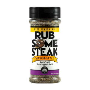 Bottle beside grilled ribeye