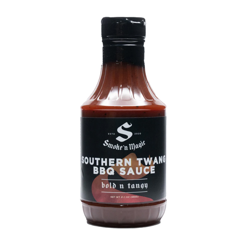 Bottle of Smoke ’N Magic Southern Twang BBQ Sauce beside pulled pork and ribs
