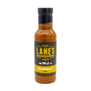 Lane’s Southbound BBQ Sauce bottle beside pulled pork and grilled chicken.