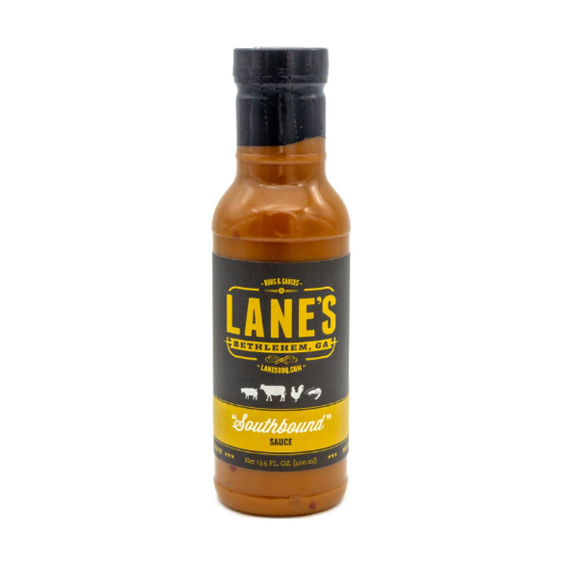 Lane’s Southbound BBQ Sauce bottle beside pulled pork and grilled chicken.