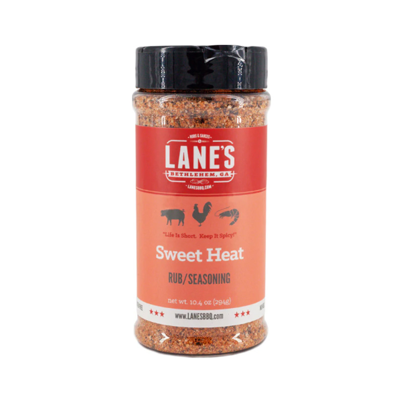 Lane’s Sweet Heat Rub jar beside glazed BBQ wings and ribs.