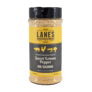 Lane’s Sweet Lemon Pepper Rub jar beside grilled salmon and lemon slices.