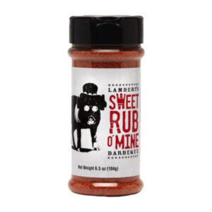Bottle of Sweet Rub O’ Mine BBQ Rub beside smoked ribs and pulled pork