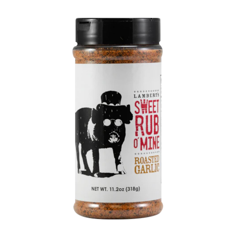 Bottle of Sweet Rub O’ Mine Roasted Garlic Rub beside grilled steak and ribs