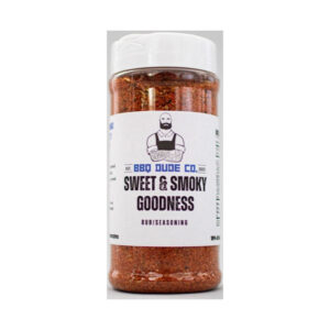 BBQ Dude Co Sweet & Smoky Goodness all-purpose BBQ seasoning bottle on wooden table with grilled meat.