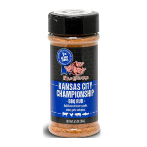 Bottle of Three Little Pigs Championship BBQ Rub beside smoked ribs and chicken