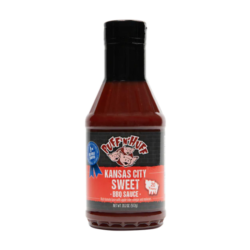 Bottle of Three Little Pigs Kansas City Style BBQ Sauce beside glazed ribs and chicken