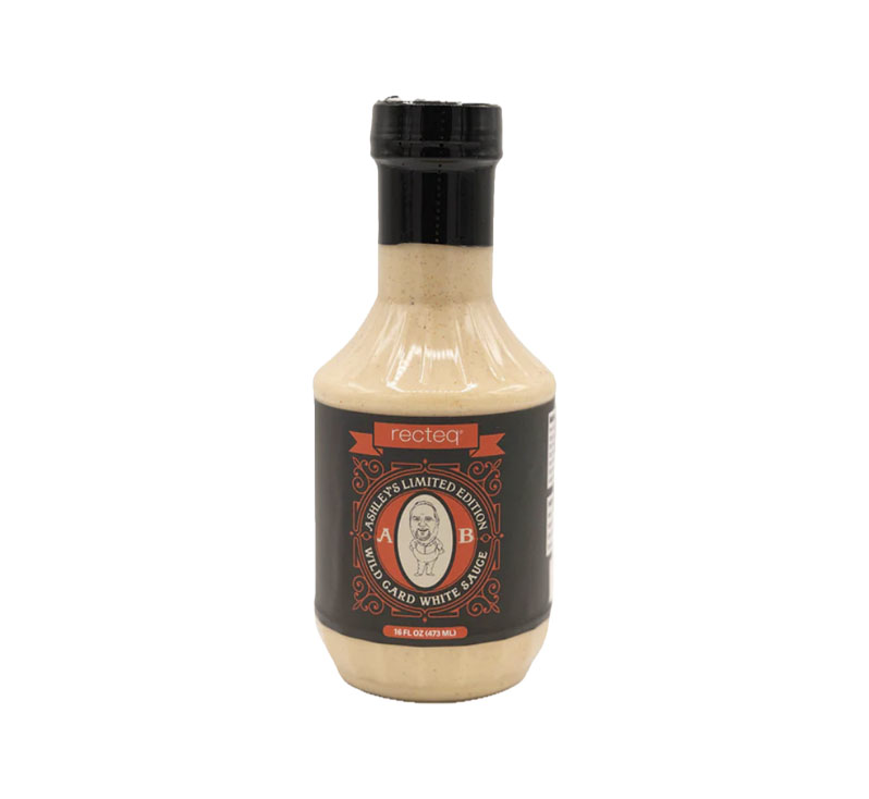 Bottle of Ashley’s Wild Card White Sauce showing creamy Southern-style BBQ sauce.