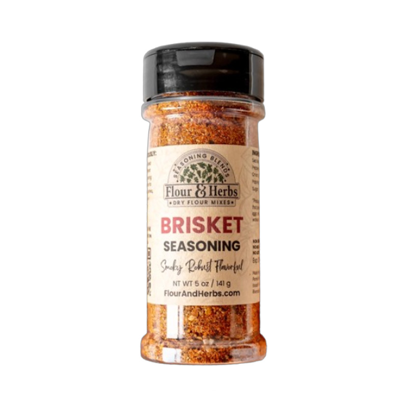 Flour & Herbs Brisket Madness Seasoning jar beside sliced smoked brisket.