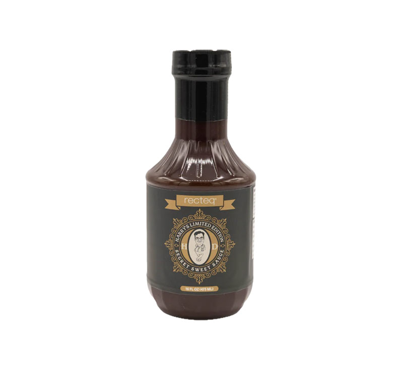Bottle of Harry’s Secret Sweet Sauce showing thick, sweet BBQ texture.