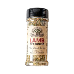 Flour & Herbs Lamb Seasoning jar beside grilled lamb chops and rosemary sprigs.