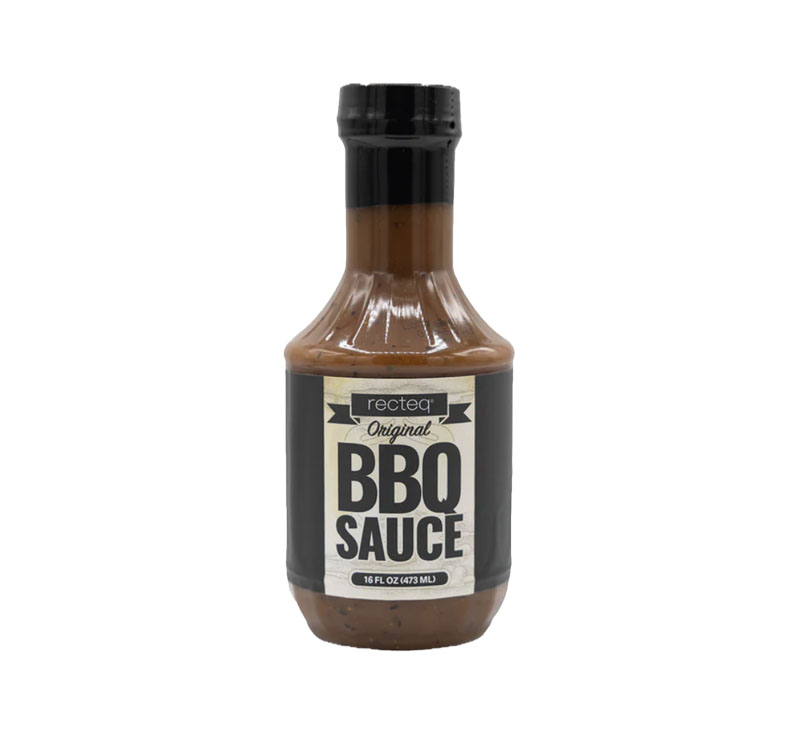 Bottle of Mild Gourmet BBQ Sauce on wooden background