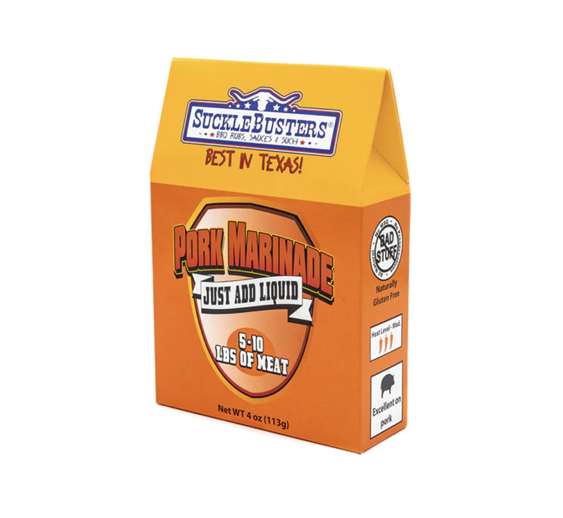 Packet of SuckleBusters Marinade for Pork on a wooden board