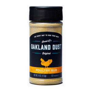 Shaker bottle of Oakland Dust Poultry Rub beside roasted chicken with golden herb crust