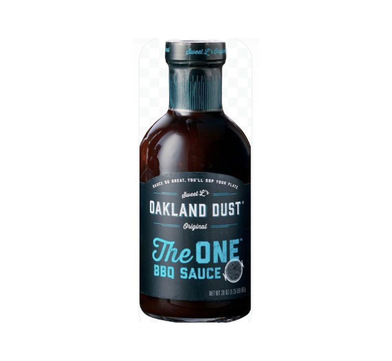 Bottle of Oakland Dust The One BBQ Sauce beside grilled ribs with glossy glaze