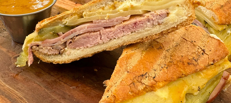 Grilled Nashville hot Cuban sandwich with pork tenderloin, ham, pickles and Swiss cheese