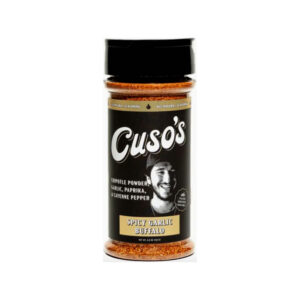 Bottle of Cuso’s Spicy Garlic Buffalo Seasoning next to a plate of buffalo wings with celery and blue cheese dip