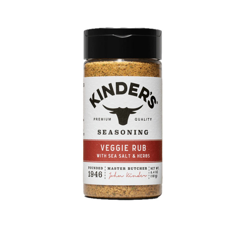 Kinder’s Veggie Rub Seasoning bottle next to fresh vegetables
