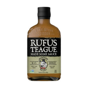 Bottle of Rufus Teague KC Gold Mustard BBQ Sauce with gold label and black cap